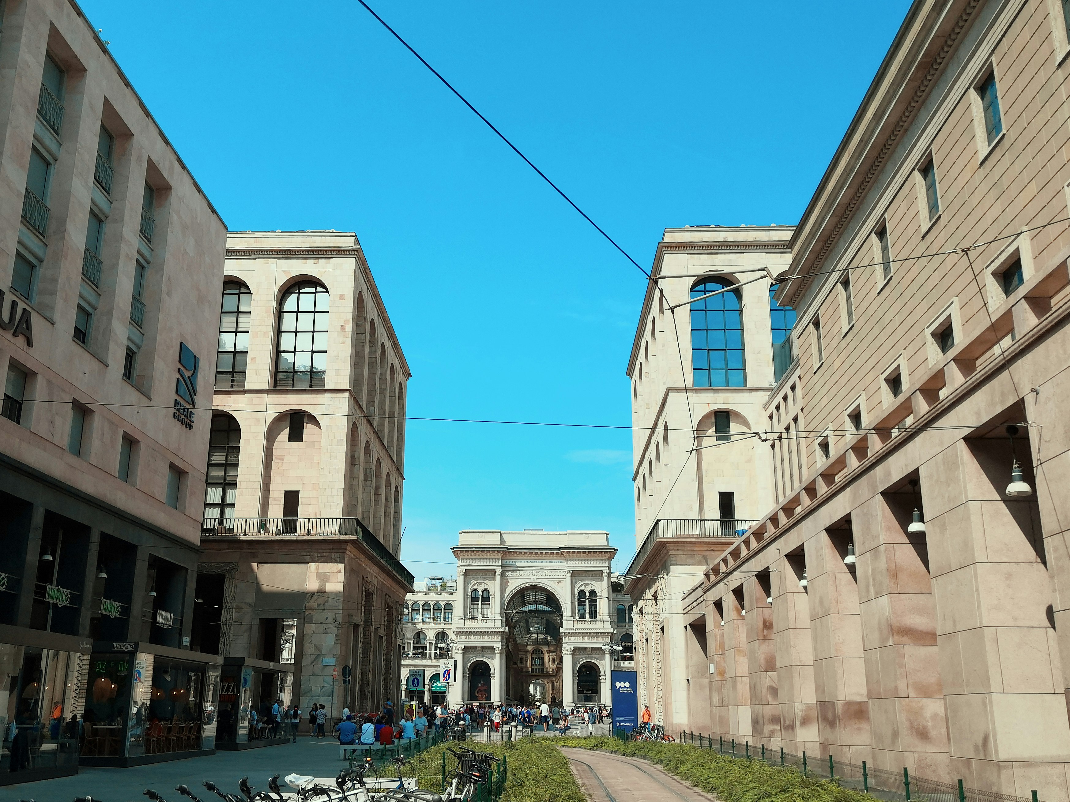 cars parked beside brown concrete building during daytime